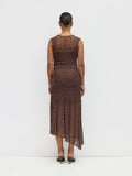 Woman wearing a brown lace dress against a white background