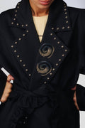 Black coat with spiral design and gold buttons on a white background