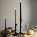 Decorative candles and glasses on a table with a neutral background