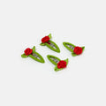 Four green hair clips with red roses on a white background
