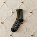 Striped sock on a textured beige surface
