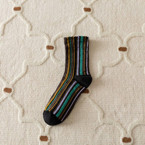 Striped sock on a textured beige surface