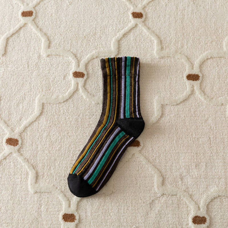 Striped sock on a textured beige surface
