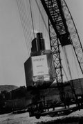Guerlain perfume bottle with a crane in the background