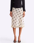 Woman wearing a polka dot skirt on a white background