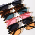 Collection of sunglasses with different colored lenses on a white background