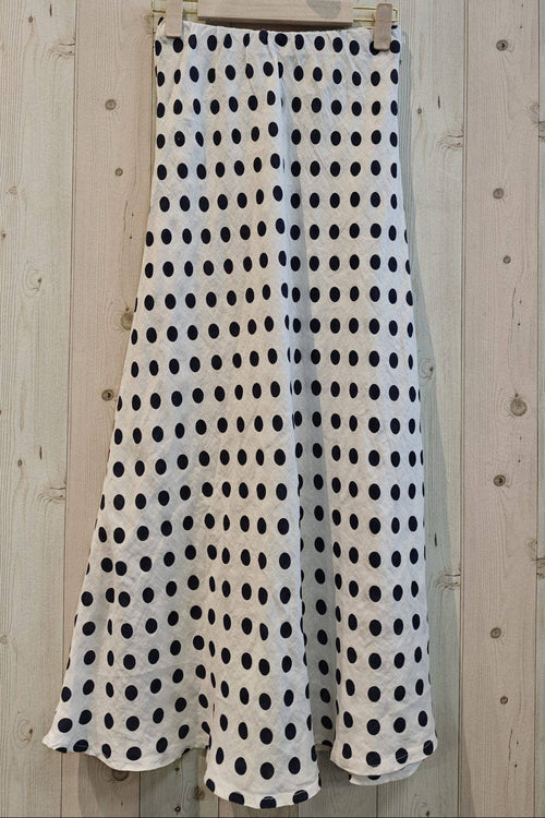 Polka dot skirt hanging on a wooden wall