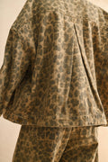 Leopard print jacket and pants on a beige background