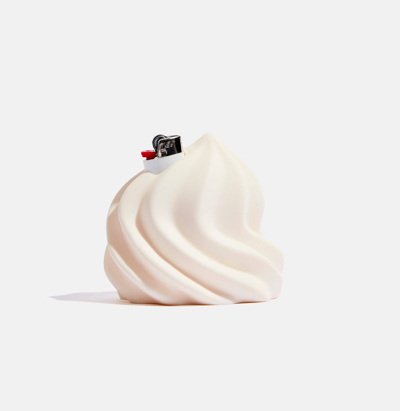 White swirled dessert with a small figure on top against a white background