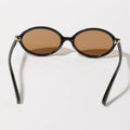 Sunglasses with black frames and brown lenses on a white background
