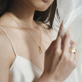 woman wearing Gold charm necklace