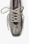 A metallic silver lace-up shoe shown from a top-down angle on a plain white background.