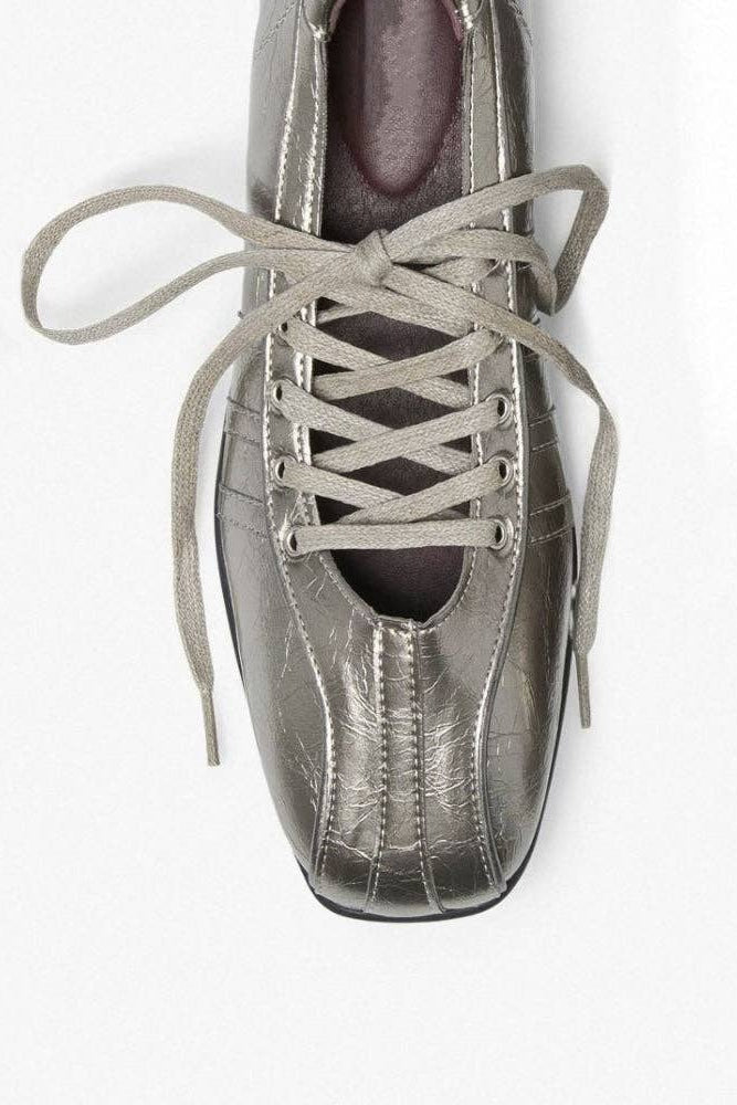 A metallic silver lace-up shoe shown from a top-down angle on a plain white background.