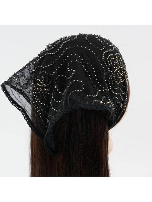 Black beaded headscarf worn by a person on a white background