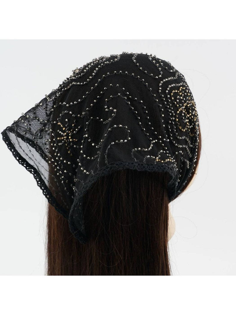 Black beaded headscarf worn by a person on a white background