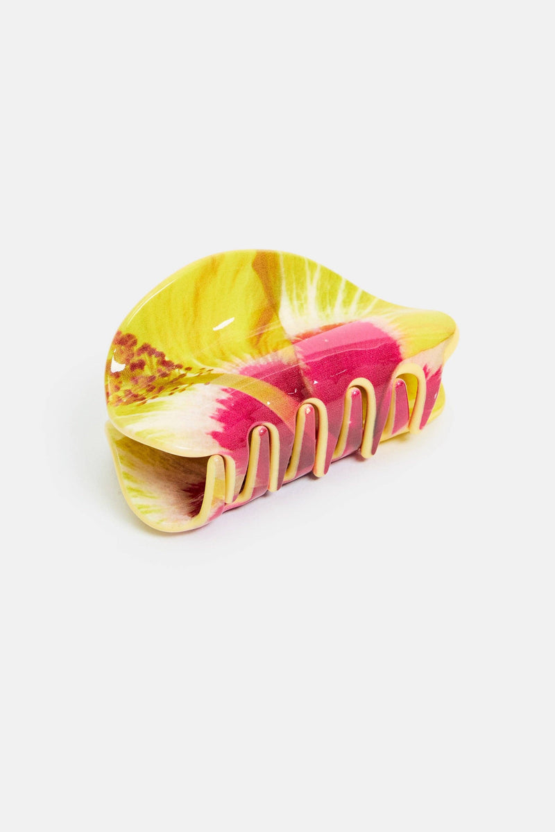 Colorful hair clip with pink and yellow design on a white background