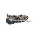 A metallic silver lace-up shoe with a black sole, shown from a side-rear angle on a white background.