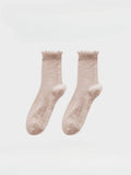 Pair of pink socks on a white background