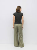 Woman wearing grey slouchy top and wide leg pant.