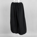 Black skirt on a mannequin against a gray background