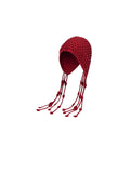 Red knitted bonnet with tassels on a white background