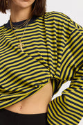 Person wearing a yellow and black striped shirt with a white background