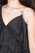 Black dress with thin straps and a close-up of the neckline.