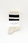 Pair of white socks with black stripes on a white background, branded 'Le Bon Shoppe'.
