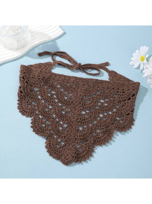 Brown crochet bikini top on a light blue background with a white flower.