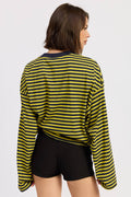 Woman wearing a yellow and black striped shirt on a white background