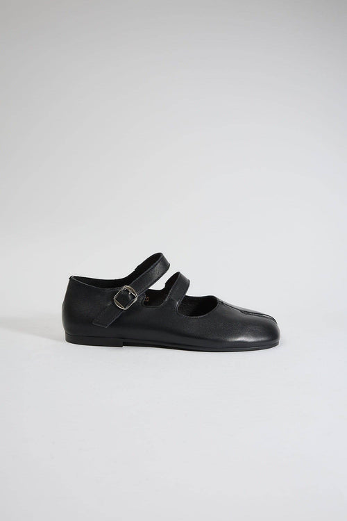 Black shoe with a strap on a white background