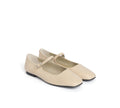 Pair of beige shoes with a strap on a white background