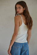 back view of Woman wearing white thin strap top