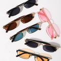 Collection of sunglasses with different colored lenses and frames on a white background