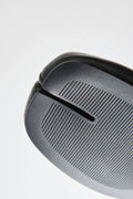 Close-up of a black golf club head on a white background