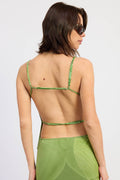Woman wearing a green bikini top on a white background