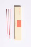 Red incense sticks with a beige box on a white background
