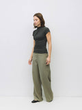 Woman wearing grey slouchy top and wide leg pant.