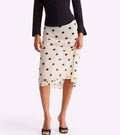 White skirt with black polka dots worn by a person on a white background