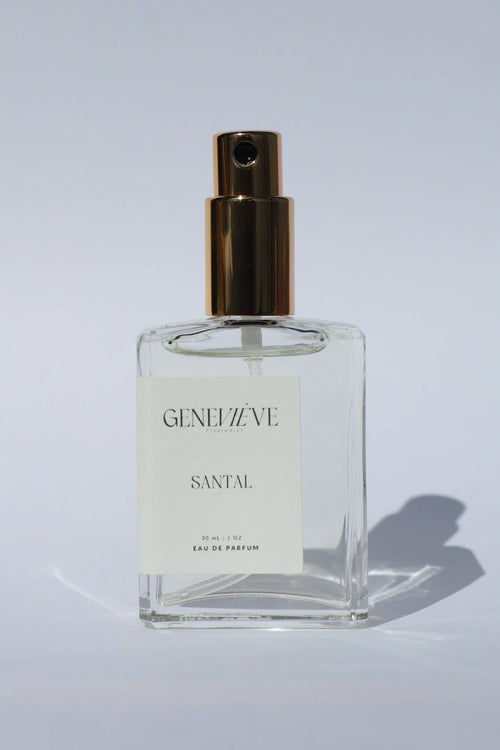 Perfume bottle labeled 'Genevieve Santal' on a light gray background
