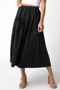 Person wearing a black skirt on a white background
