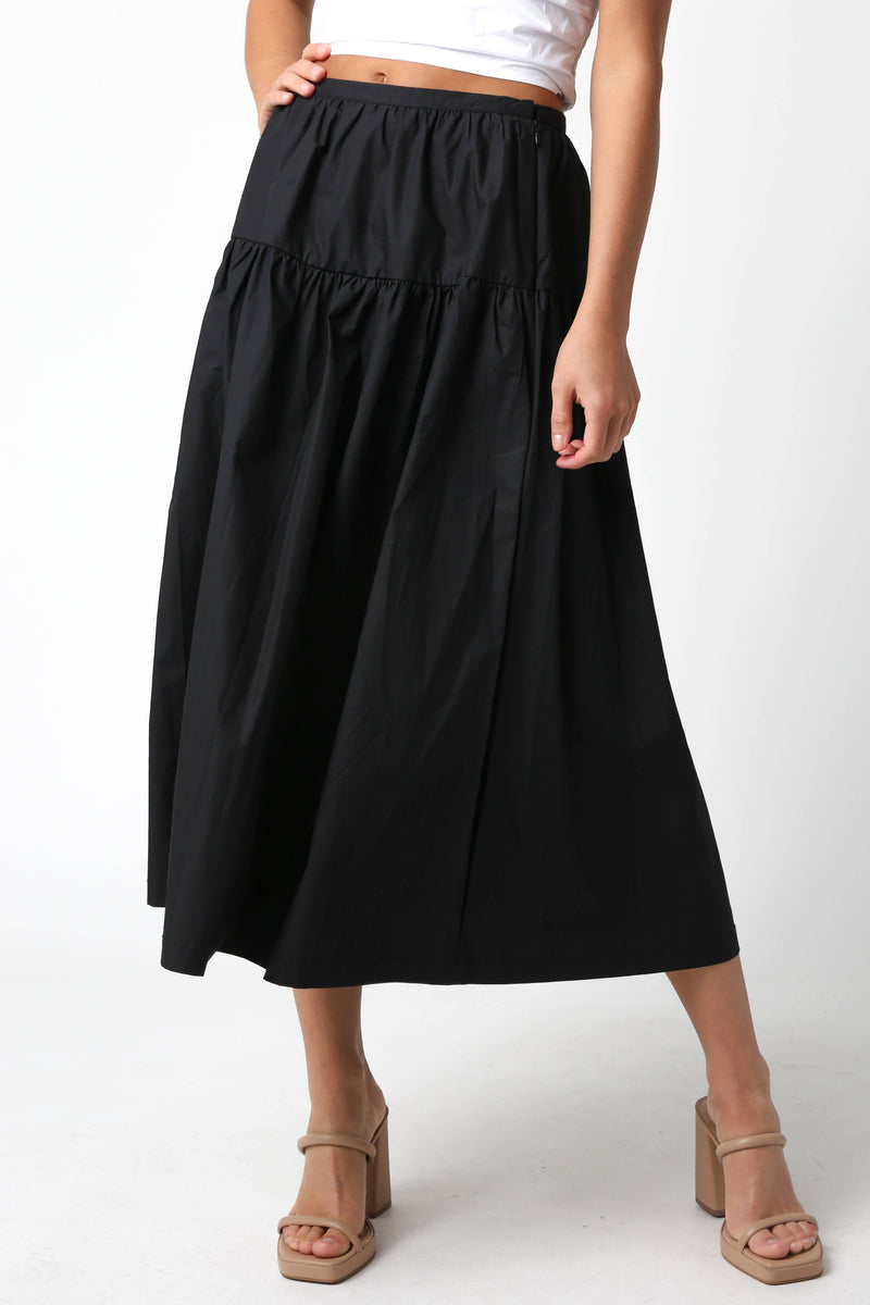 Person wearing a black skirt on a white background