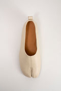 A single light beige leather split-toe flat shoe shown from a top-down view on a light gray background.