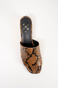 A single women's slide sandal with a brown and black snakeskin pattern, featuring a low block heel and an open toe. The insole displays the brand name 'KMB' in gold lettering.