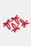 Four red hair clips with bow designs on a light gray background