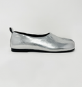 Silver slip-on shoe on a white background