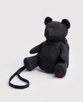 Black teddy bear-shaped backpack on a light gray background