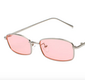 Sunglasses with pink lenses and silver frame on a white background