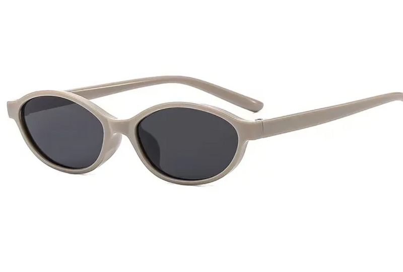 Beige sunglasses with dark lenses on a white background