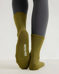 Green socks with 'Arctic Fox' branding worn by a person on a white background